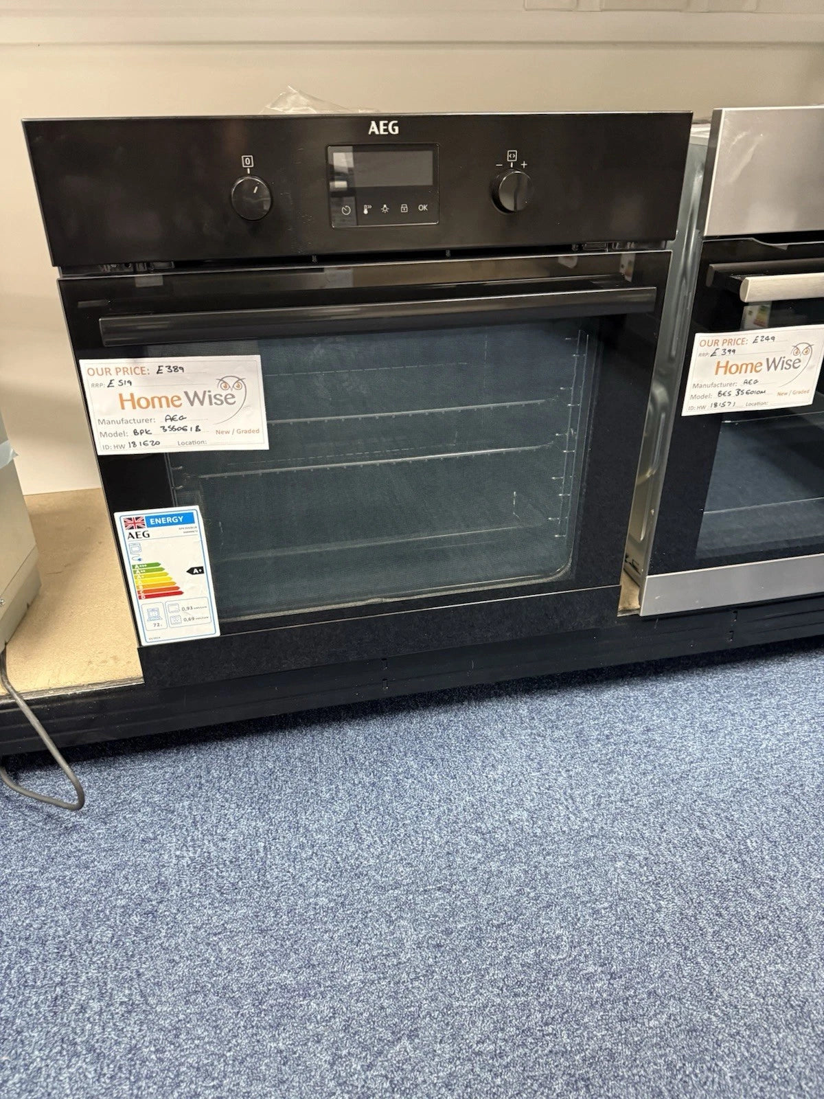 AEG BPK355061B (20) Electric Built-In Single Oven with Pyrolytic Self Cleaning in Black - A+ Rated from HomeWise Appliances. Shop photo of oven on show stand with the door closed showing the A+ energy rating label