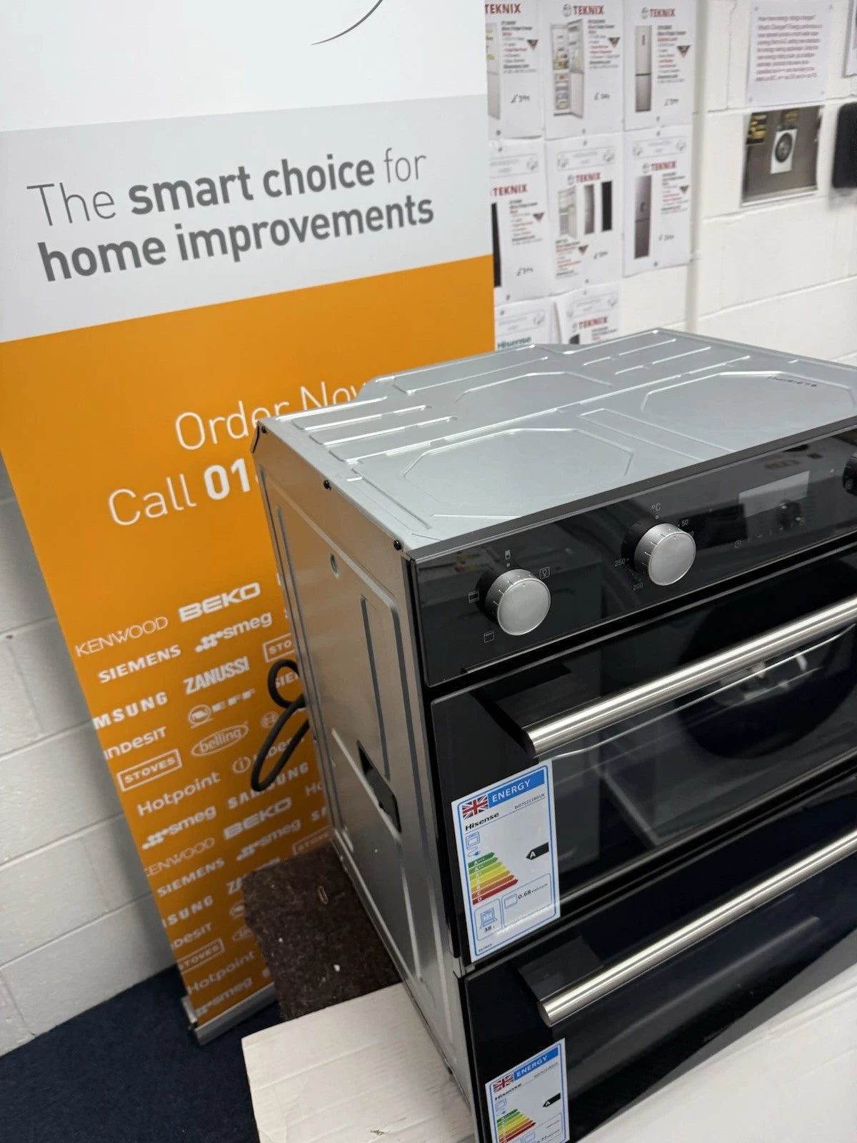 Hisense BID75211BGUK (78) Built-Under Electric Double Oven in Black - A/A Rated - HW181678 shop photo front of oven showing energy efficiency label of A rated for each cavity.