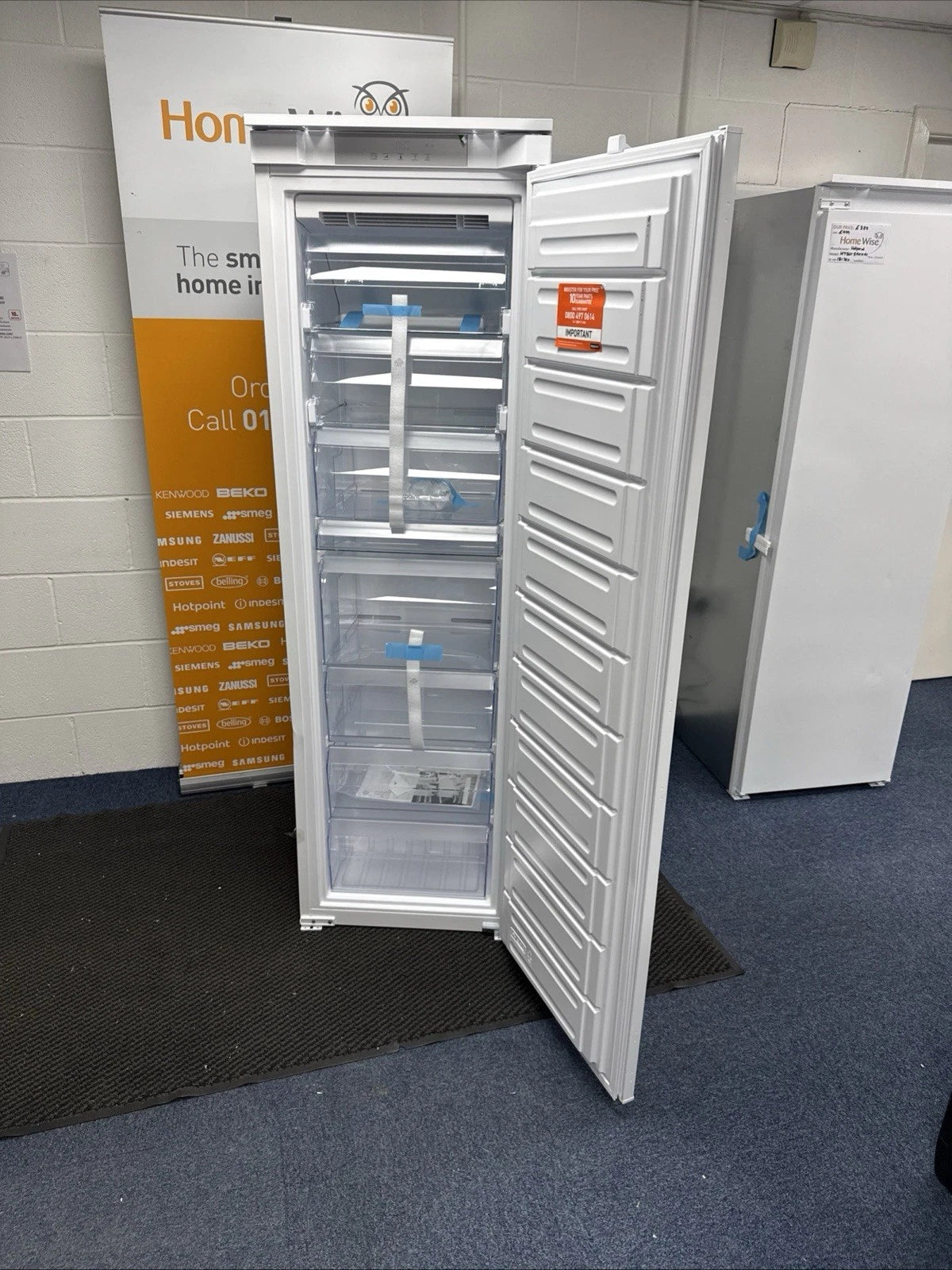 Hotpoint HTSD18F013H1 209 Litre Tall Built-In Freezer with No Frost - E Rated from HomeWise Appliances. Shop photo of the tall freezer with door open showing the inside.