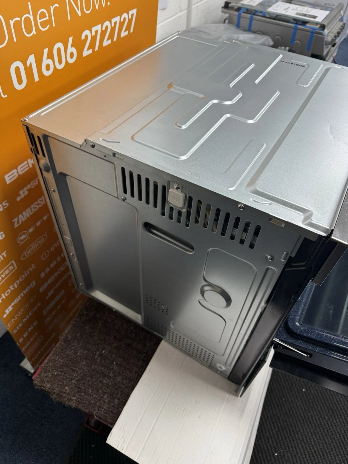 Samsung NV7B5755SAS Flexible Dual Cook Built-in Smart Single Oven with Pyrolytic Self Cleaning and Air Fry in Stainless Steel - A+ Rated from HomeWise Appliances. Shop photo of outer top casing and left side panel of the oven.