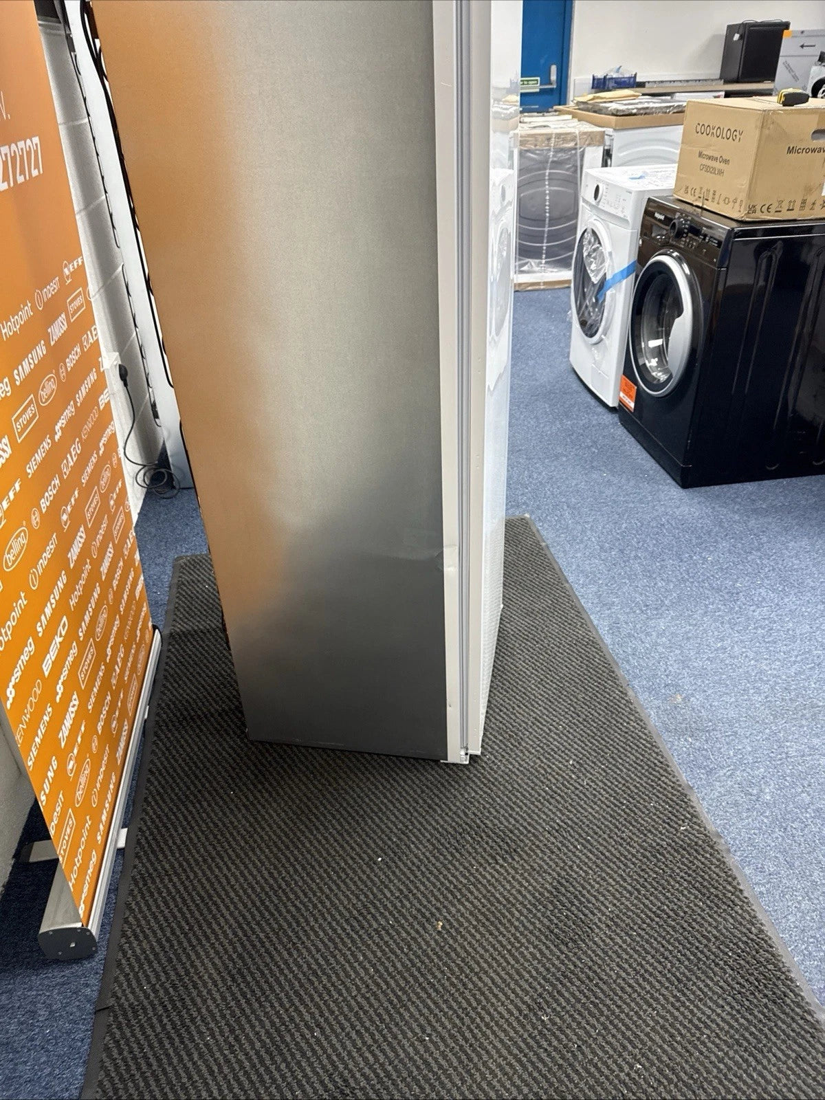 Hotpoint HTSD18F013H1 209 Litre Tall Built-In Freezer with No Frost - E Rated from HomeWise Appliances. Shop photo showing left side panel with slight dent on the front edge.