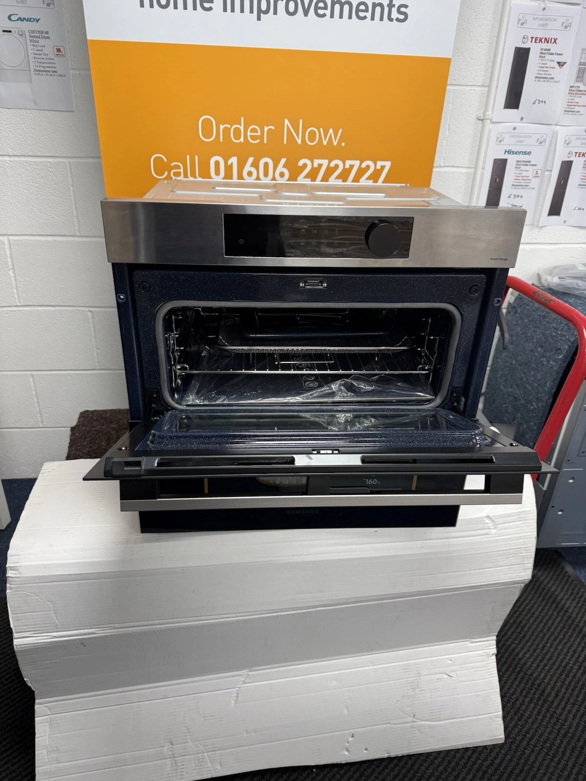 Samsung NV7B5755SAS Flexible Dual Cook Built-in Smart Single Oven with Pyrolytic Self Cleaning and Air Fry in Stainless Steel - A+ Rated from HomeWise Appliances. Shop photo of front of the oven with top half of the split door open.