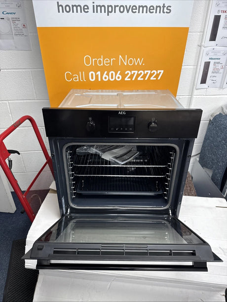 AEG BPK355061B (20) Electric Built-In Single Oven with Pyrolytic Self Cleaning in Black - A+ Rated from HomeWise Appliances. Shop photo oven with door open in front of a call to action sales banner, order now call 01606 272727