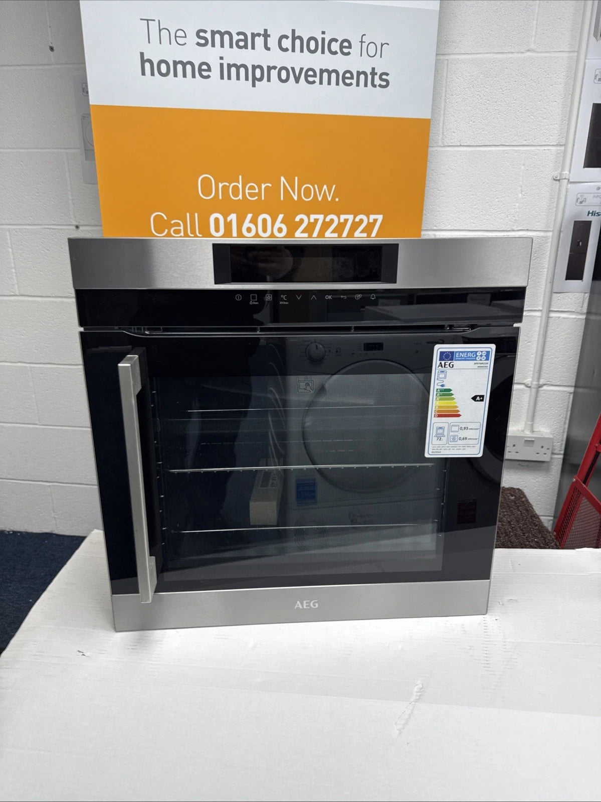 AEG BPK744R21M Built-In Single Oven with Right Side Opening Door Pyrolytic Self Cleaning in Stainless Steel - A+ Rated Showroom Photo front with door closed and sales banner