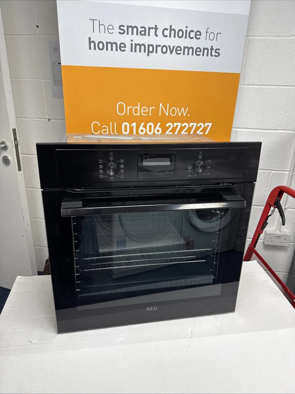 AEG BEX335011B SurroundCook Built-In Electric Single Oven in Black - A Rated showroom photo front door closed with sales banner