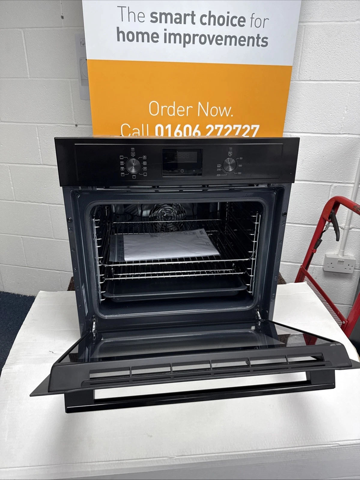 AEG BEX335011B SurroundCook Built-In Electric Single Oven in Black - A Rated showroom photo front door open with sales banner