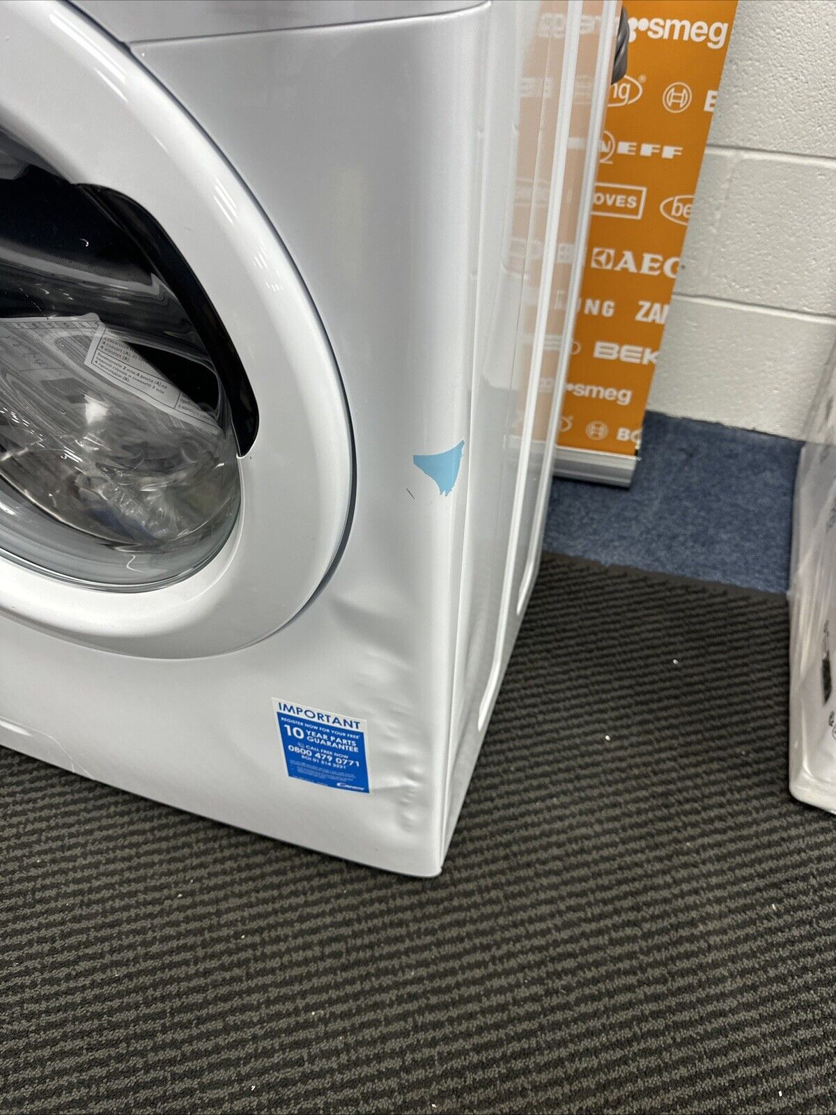 Candy CS1410TE/1-80 10kg 1400 Spin Wi-Fi Enabled Washing Machine in  White - Graded showroom photo with close up picture of front damage