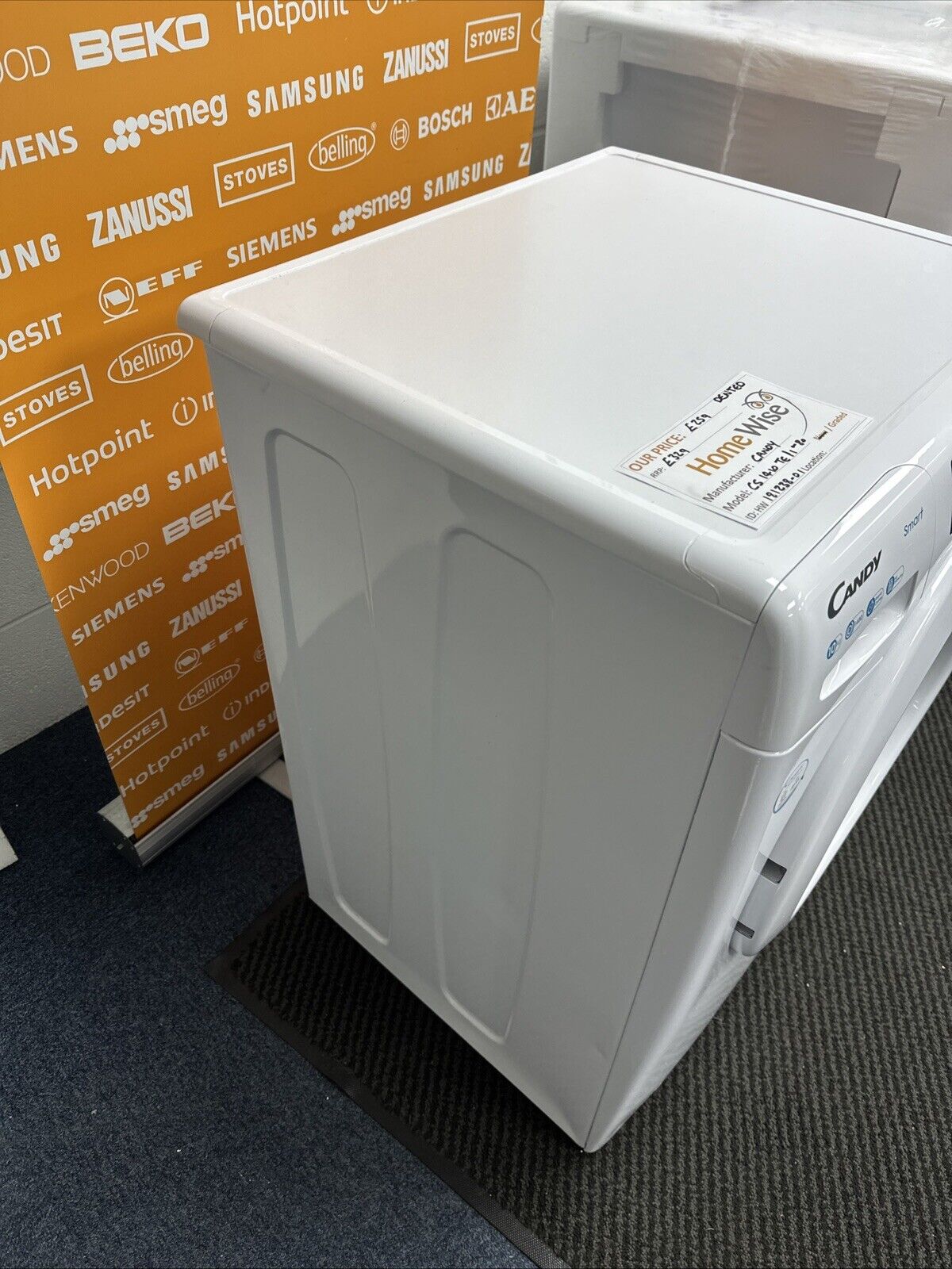 Candy CS1410TE/1-80 10kg 1400 Spin Wi-Fi Enabled Washing Machine in  White - Graded showroom photo showing small dents on the left side panel