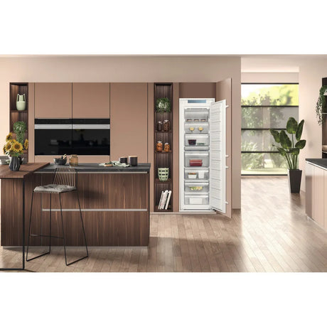 Hotpoint HTSD18F013H1 209 Litre Tall Built-In Freezer with No Frost - E Rated from HomeWise Appliances. Stock photo of the freezer with door open in a kitchen environment.