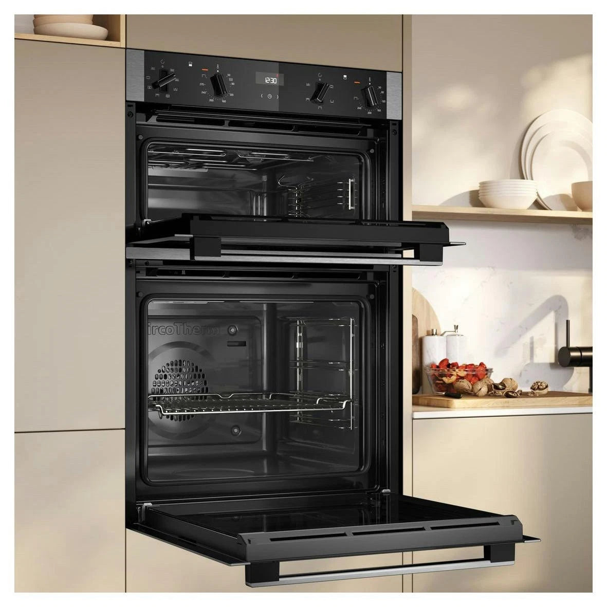 Neff N50 U1ACE2AN3B Built-in Electric Double Oven in Stainless Steel - A/B Rated by HomeWise Appliances. Stock photo showing oven in a kitchen setting with the doors open.