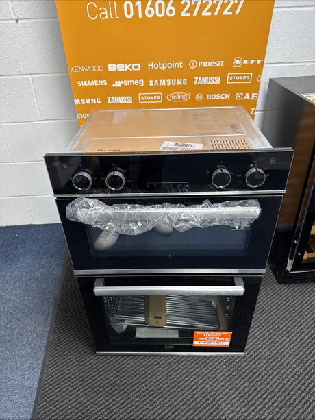 Beko BBXDF25300X Electric Double Built-in Oven in Black & Stainless Steel - A/A Rated shop photo of oven in front of call to action sales banner. Call 01606272727