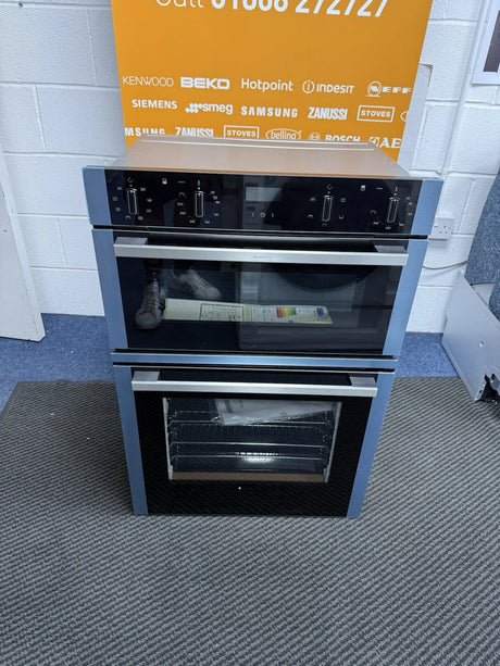 Neff N50 U1ACE2HN0B (10) Built-In Electric Double Oven in Stainless Steel - A Rated from HomeWise Appliances shop photo front of oven with protection film