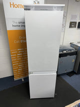 Hotpoint HTC18 T112 UK 70/30 No Frost Integrated Fridge Freezer with Sliding Hinge - E Rated from HomeWise Appliances. Shop photo with the doors closed as unit in front of a sales banner