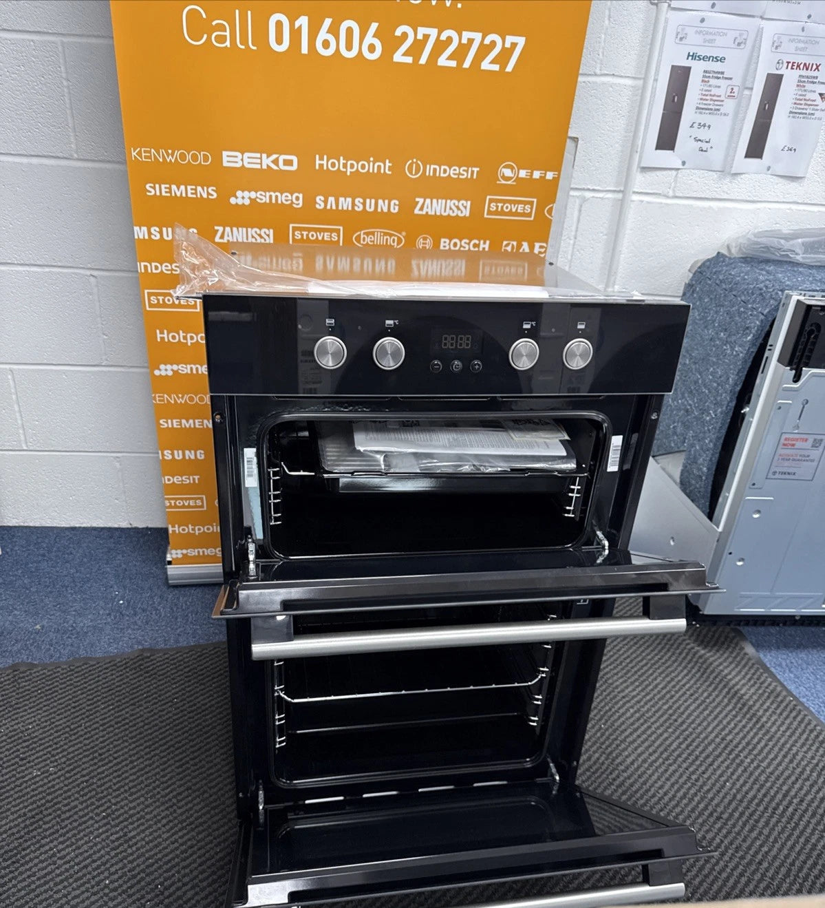 Hotpoint Series 2 DD2 844 C BL Double Built-in Oven in Black - A/A Rated from HomeWise Appliances shop photo of the oven close up with doors open showing furniture and accessories