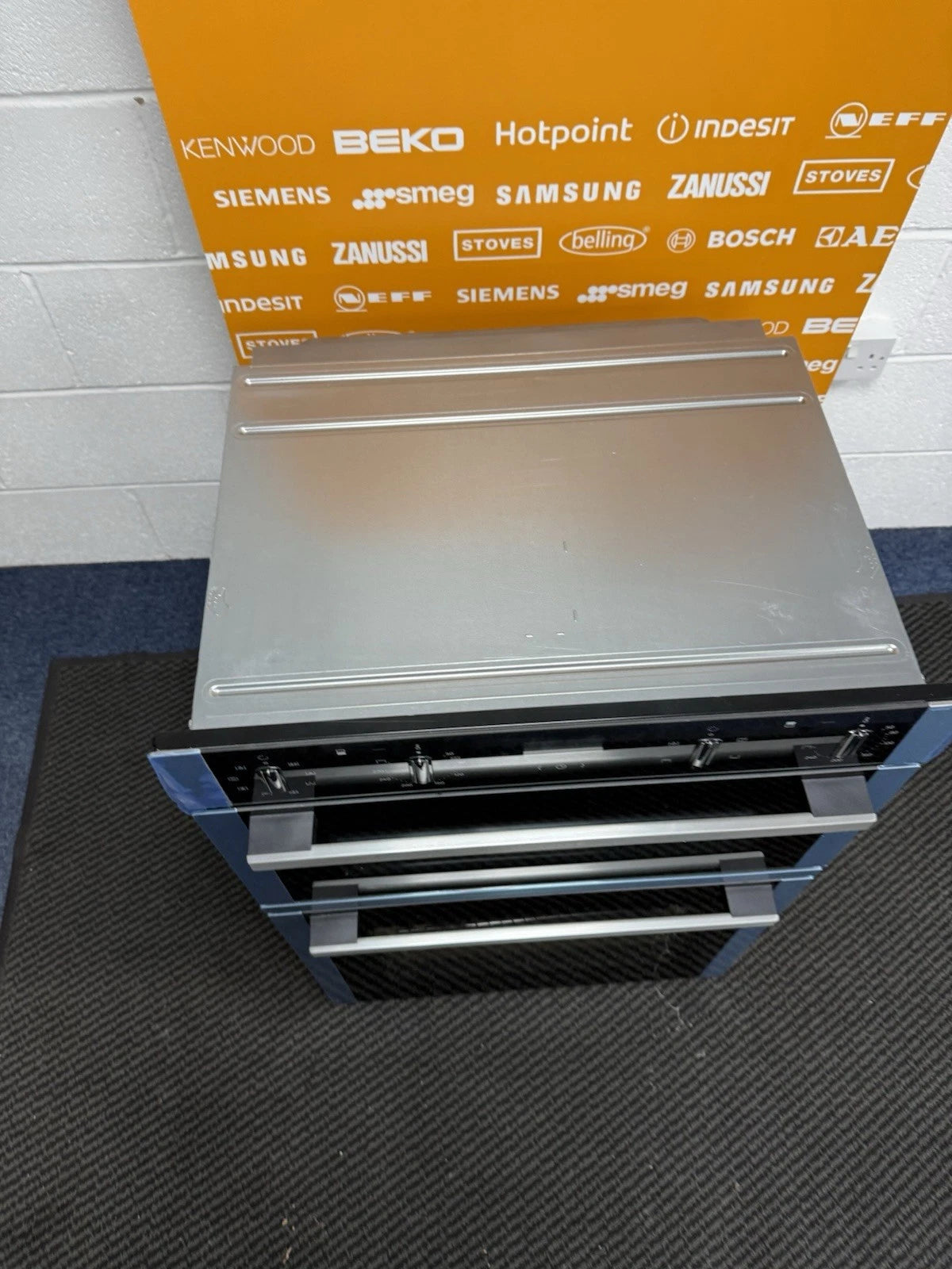 Neff N50 U1ACE2AN3B Built-in Electric Double Oven in Stainless Steel - A/B Rated by HomeWise Appliances. Showroom photo of top of oven showing light scuff marks.