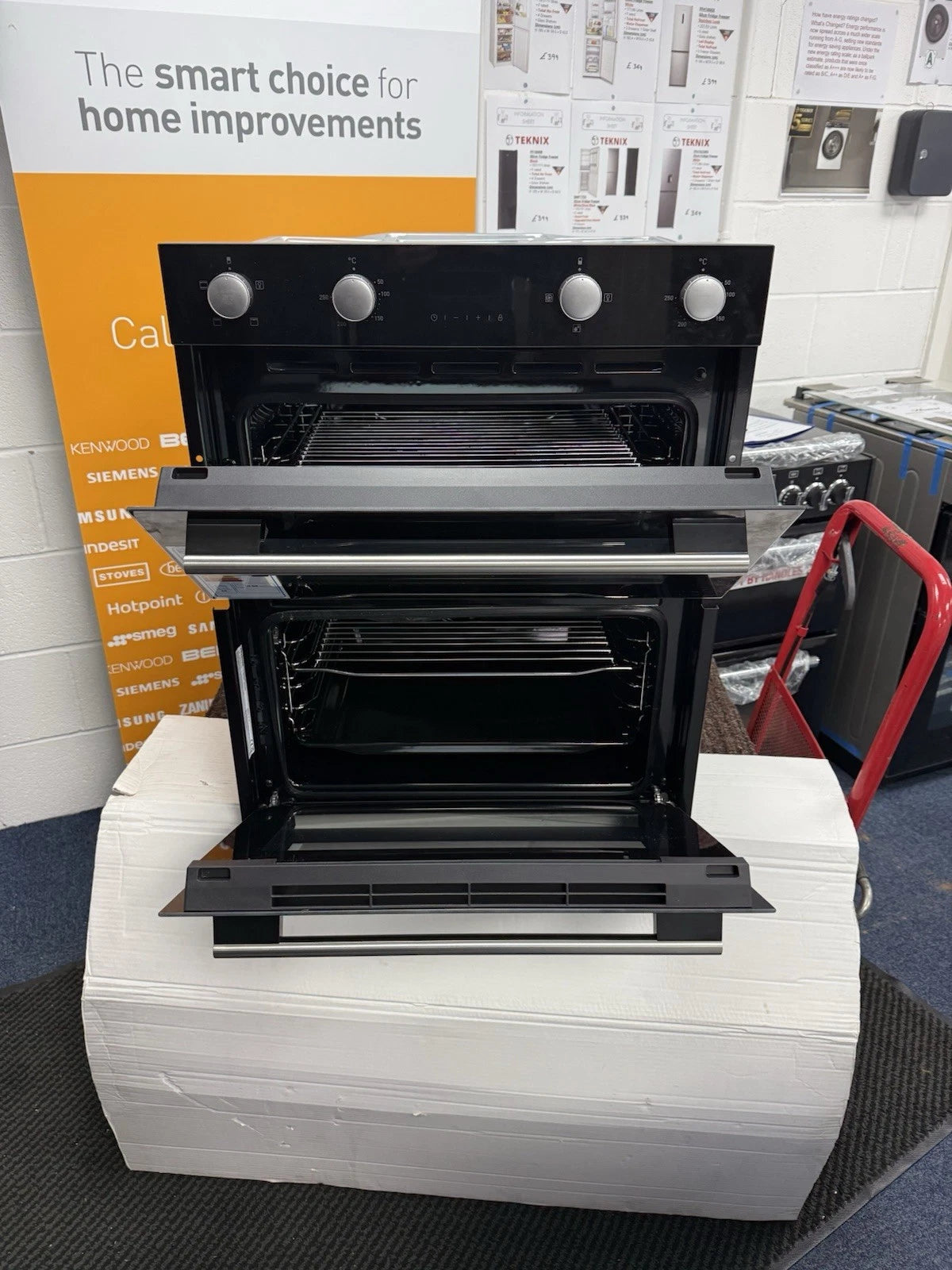 Hisense BID75211BGUK (78) Built-Under Electric Double Oven in Black - A/A Rated - HW181678 oven in front of a sales banner with "The smart choice for home improvements"